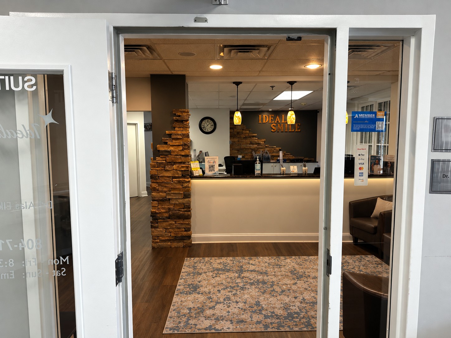 View from the office entrance toward reception, stone columns and seating
