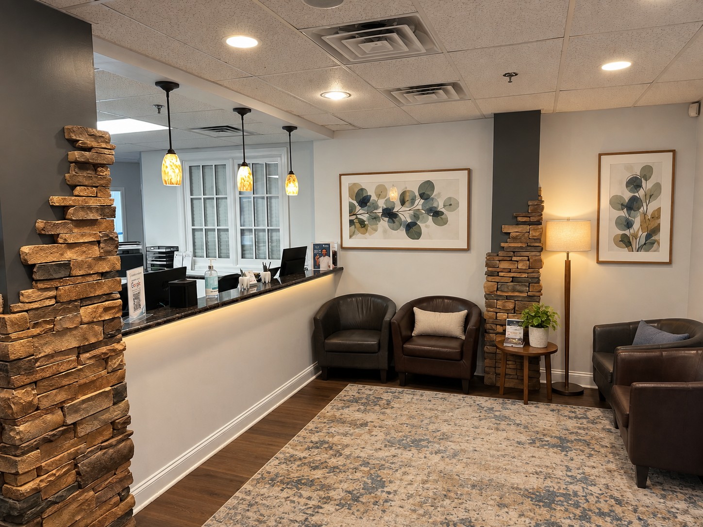 Ideal Smile Dentistry reception and waiting area with stone columns and armchairs